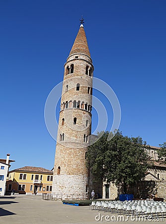 askew bell tower of cathedral Saint Stephen Protomartyr in the mediterranean town Caorle (North Italy) Stock Photo