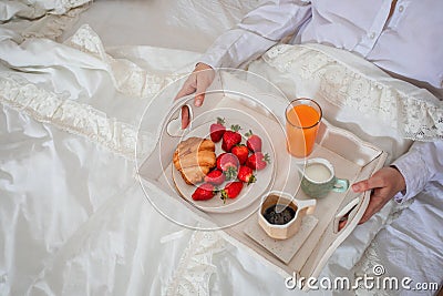 Romantic atmosphere in bedroom, sweet breakfast on tray Stock Photo