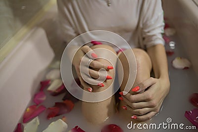 Romantic bath with white water and rose petals Stock Photo