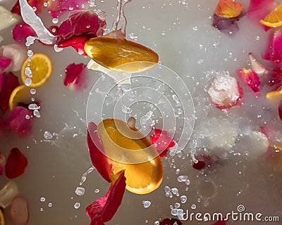 Romantic bath with white water and rose petals Stock Photo