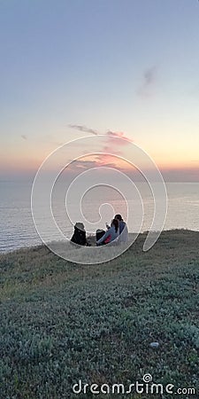 Summer evening. Family with a dog by the sea Stock Photo