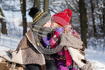 Little girl kissing boy with gift outdoors Stock Photo