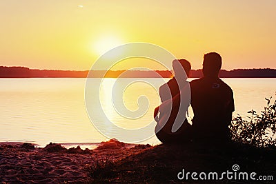 Romantic couple on the beach at colorful sunset background Stock Photo