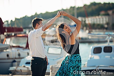 Romantic couple dancing on the street. Having a romantic date. Celebrating anniversary. Valentines day. Birthday date Stock Photo