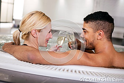 Romantic couple drinking cahmpagne in hot tub Stock Photo