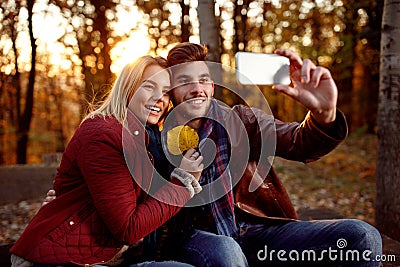 Romantic couple having fun outdoors and taking selfie with mobil Stock Photo