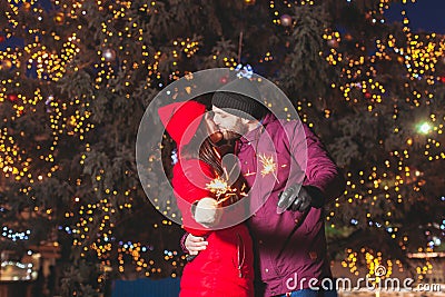 Romantic couple hugging and kissing holding bengal fires Stock Photo
