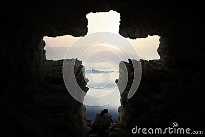 Romantic couple inside cave shaped cross Stock Photo