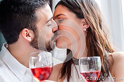 Romantic couple kissing at dinner. Stock Photo