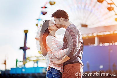 Romantic couple kissing infront of santa monica Stock Photo