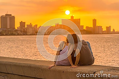 Romantic couple looking at a sunset in Havana Editorial Stock Photo