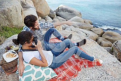 Romantic couple, during a picnic on the rocks Stock Photo