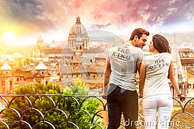 Romantic couple in Rome, Italy. A men and a women, they are looking at each other. On a terrace with railing overlooking Rome at Stock Photo