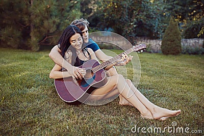 Romantic couple sitting on the grass in the garden Stock Photo