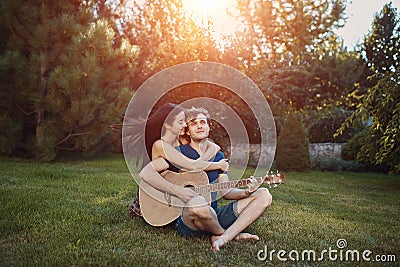 Romantic couple sitting on the grass in the garden Stock Photo