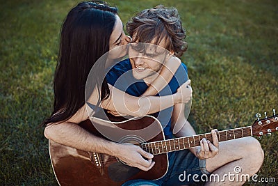 Romantic couple sitting on the grass in the garden Stock Photo