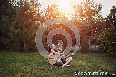 Romantic couple sitting on the grass in the garden Stock Photo