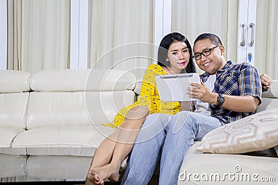 Romantic couple using a digital tablet at home Stock Photo