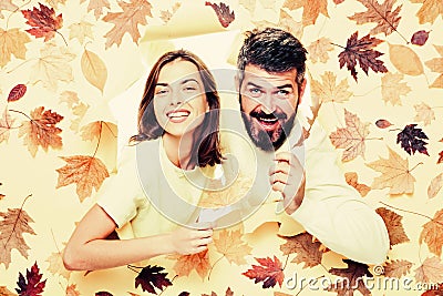 Romantic couple wearing pullover on autumn leaves background. Autumn mood and weather warm and sunny. Surprised couple Stock Photo