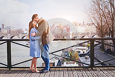 Romantic dating, young couple kissing on the bridge in Paris Stock Photo