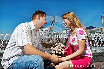 Romantic dating young guy and girl in city square Stock Photo