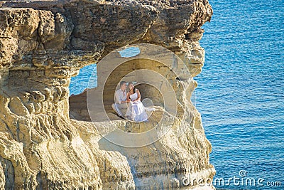 Romantic dating. Young loving couple embracing and enjoying sea Stock Photo