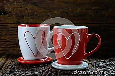 Romantic design of two coffee cups with heart shape pattern and coffee beans Stock Photo