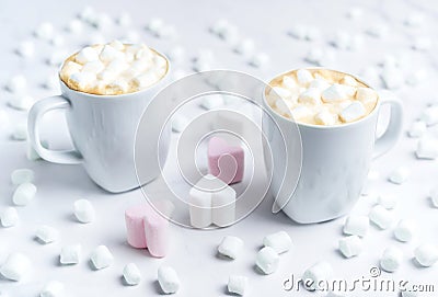 Romantic desk top with two cups of coffee with marshmallows on marble table. Stock Photo