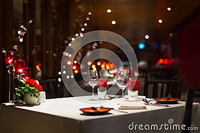 Romantic dinner setup, red decoration with candle light in a res Stock Photo