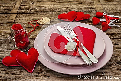 Romantic dinner table. Love concept for Valentines or mother`s day, wedding cutlery. Vintage wooden boards background Stock Photo