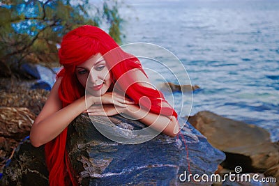 Romantic dreamer girl in mermaid costume on sea side Stock Photo