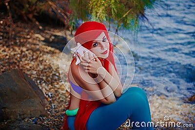 Romantic dreamer girl in mermaid costume on sea side Stock Photo