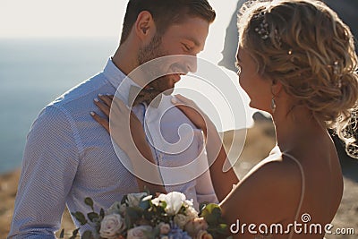 Romantic fairy tale couple of newlyweds hugs and kisses at sunset. Stock Photo