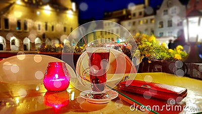 Romantic holiday city light Street cafe bokeh blurring city light evening restaurant table cup of coffee on top view candle lamp Stock Photo