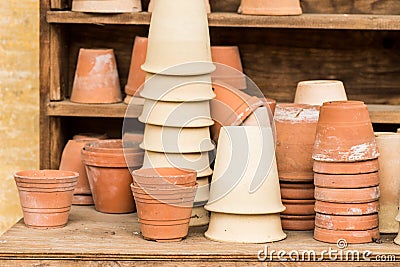 Romantic idyllic plant table in the garden with old retro terracotta flower pot pots Stock Photo