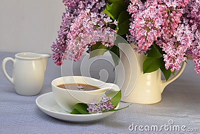 romantic image of a bouquet of lilacs and a cup of coffee Stock Photo