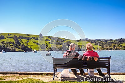 Romantic image of old retired couple admiring peaceful landscape Editorial Stock Photo