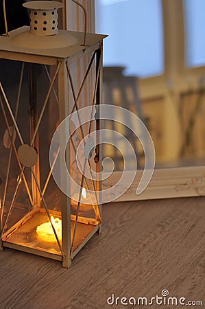 Romantic lantern reflection. Decorative mirror frame. Relaxing candlelight flame. Peaceful home interior Stock Photo