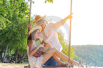 Romantic lifestyle asian couples lover playing an ukulele on the hammock. relax Stock Photo