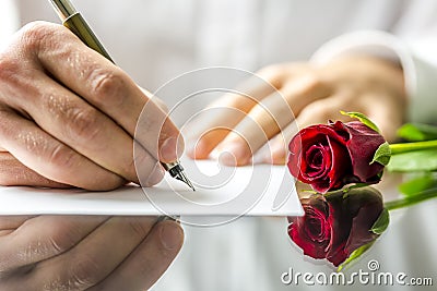 Romantic man writing a love letter Stock Photo