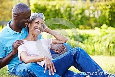 Romantic Mature Couple Sitting In Garden Stock Photo