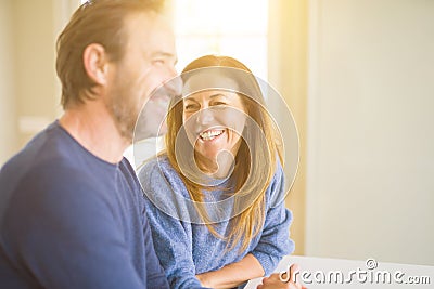 Romantic middle age couple sitting together at home Stock Photo