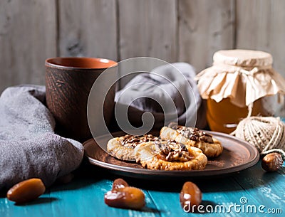 Romantic morning still life, in a rustic style with cookies, a glass jar of honey Stock Photo