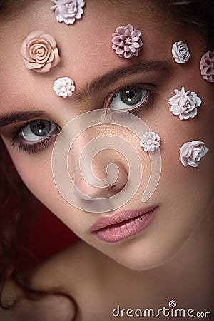 Romantic nude young beautiful girl with white flowers on her face Stock Photo