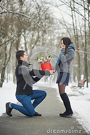 romantic offer to get married. man makes an offer to his girlfriend in winter park. Valentine day Proposal concept. Young man Stock Photo