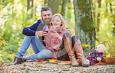 Romantic picnic with wine in forest. Couple in love celebrate anniversary picnic date. Couple cuddling drinking wine Stock Photo