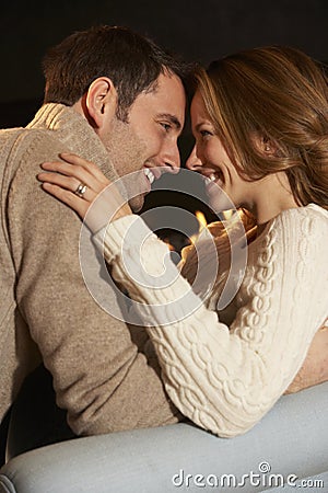 Romantic portrait couple in front of fire Stock Photo