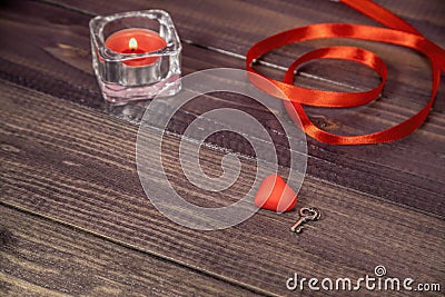 red valentine, candle, ribbon and a silver key Stock Photo