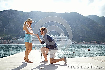 Romantic proposal on the lake. man proposal his girl on vacation Stock Photo