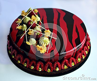 Romantic red and black raspberry cake with pistachio ganache and fresh berries Stock Photo